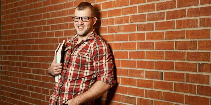 guy by brick wall